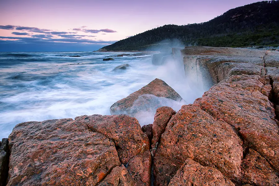 Waves crashing on sunset at Bicheno, Tasmania